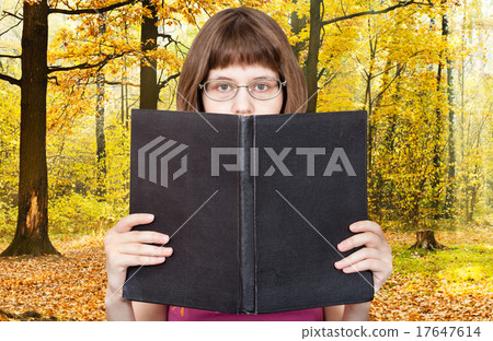 girl reads big book and autumn woods girl reads big book and autumn woods 17647614