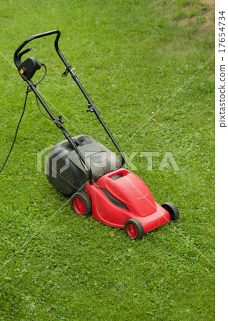 red lawnmower on green grass 17654734