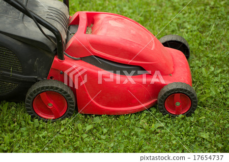 red lawnmower on green grass red lawnmower on green grass 17654737