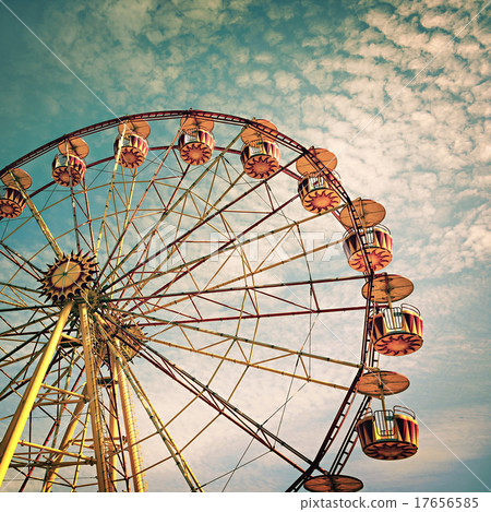 yellow ferris wheel against a blue sky 17656585