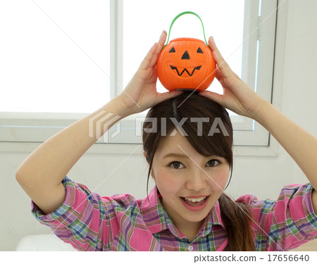 A woman with a pumpkin haunted Halloween 17656640
