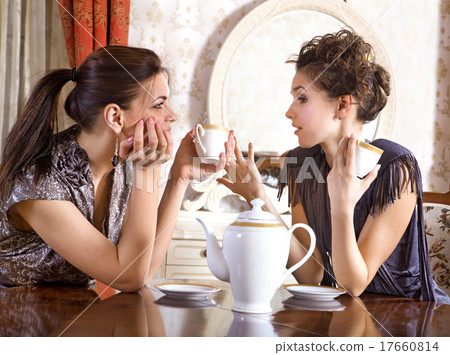 Two pretty girl-friends drink tea Two pretty girl-friends drink tea 17660814