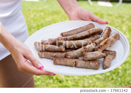 Woman serving sausage Woman serving sausage 17661142
