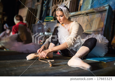 Ballerina sitting on the warm-up backstage 17665325