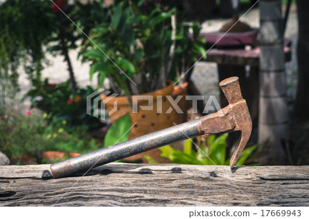 Hammer on wooden bench and wooden background 17669943