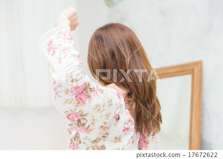A woman unraveling her shoulders A woman unraveling her shoulders 17672622