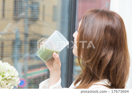 A woman drinking a health drink A woman drinking a health drink 17673604