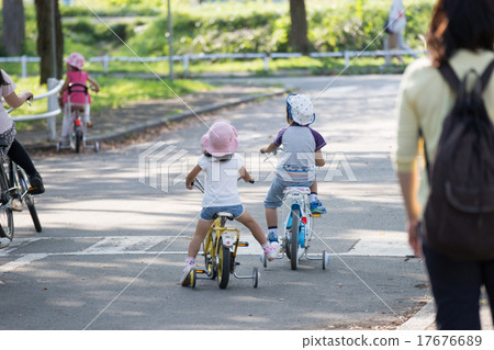 Children riding a bicycle Children riding a bicycle 17676689