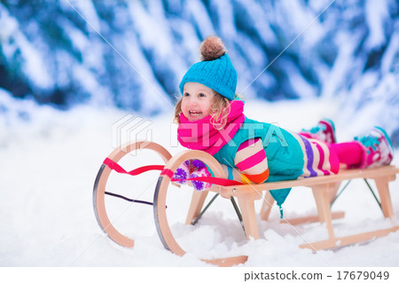 Little girl playing in snowy winter forest 17679049