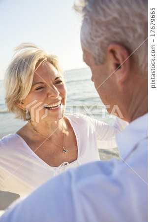 Happy Senior Couple Walking Holding Hands Tropical Beach 17679665