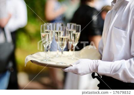 Waiter with dish of champagne glasses 17679832