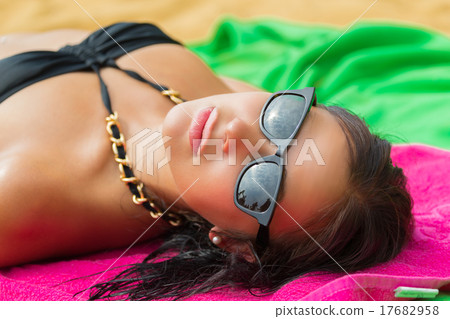 Woman on beach gets sun tan 17682958