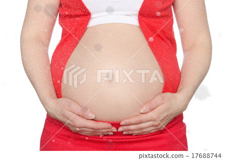 Pregnant woman supports stomach with falling snow 17688744