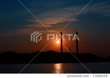 factory in silhouette and sunrise sky 17689359