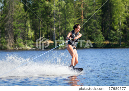 Young woman study riding wakeboarding on a lake 17689577