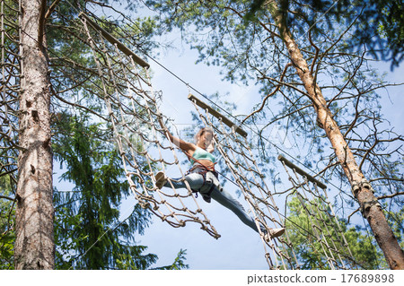 Woman at adventure rope park Woman at adventure rope park 17689898