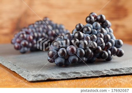 Blue grape clusters on slate board Blue grape clusters on slate board 17692087
