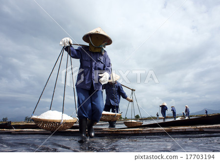 Salt worker working on saline Salt worker working on saline 17703194
