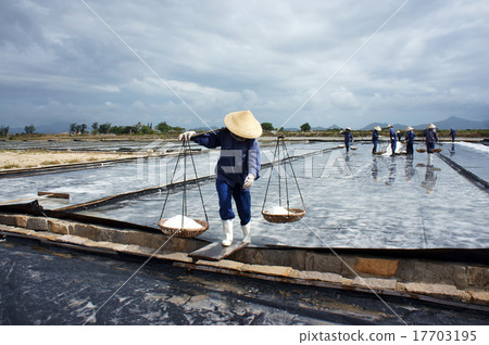 Salt worker working on saline Salt worker working on saline 17703195