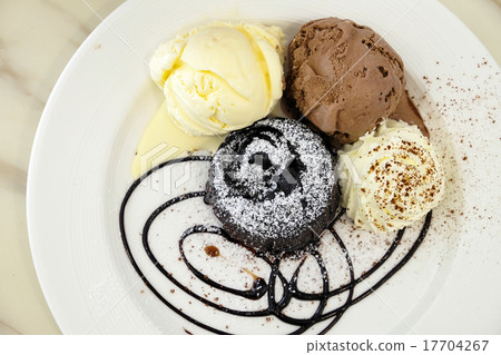 Chocolate lava cake with ice-cream in the dish Chocolate lava cake with ice-cream in the dish 17704267