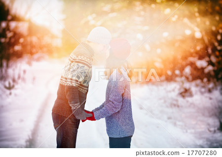 Young couple in love kissing outdoors in winter Young couple in love kissing outdoors in winter 17707280