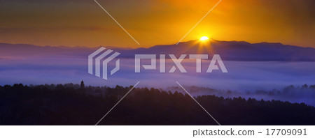 Misty dawn over wooded mountains Misty dawn over wooded mountains 17709091