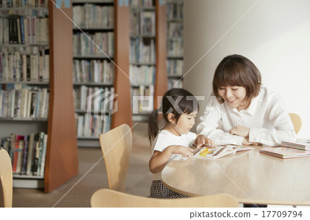 Parents reading picture books at the library 17709794