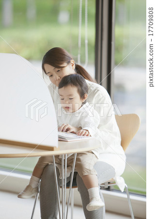 Parents reading picture books at the library 17709808