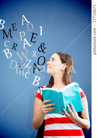 Composite image of student reading book in library 17710671