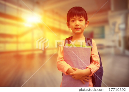 Composite image of cute pupil looking at camera holding notepad Composite image of cute pupil looking at camera holding notepad 17710892