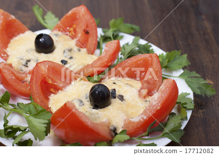 Baked tomatoes stuffed with cheese and olives. 17712082