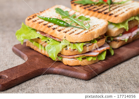 Classic club sandwich with bacon and vegetables Classic club sandwich with bacon and vegetables 17714056