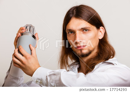 Young man with shaker making cocktail drink Young man with shaker making cocktail drink 17714293