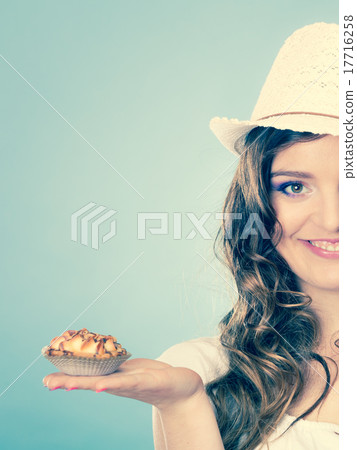 attractive woman holds cake in hand 17716258
