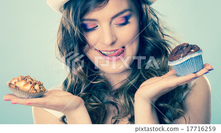 Smiling summer woman holds cakes in hand Smiling summer woman holds cakes in hand 17716259