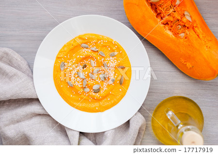 Pumpkin cream-soup with seeds in a white plate Pumpkin cream-soup with seeds in a white plate 17717919