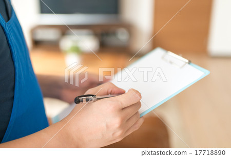 Male staff in housekeeping business wearing a blue apron 17718890