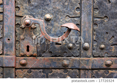 Old door handle on iron medieval door. 17720324