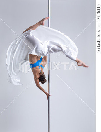 Graceful girl hanging upside down on pylon Graceful girl hanging upside down on pylon 17726316