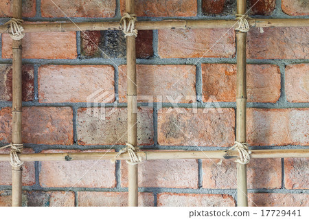 Old brick wall with tied bamboo Old brick wall with tied bamboo 17729441