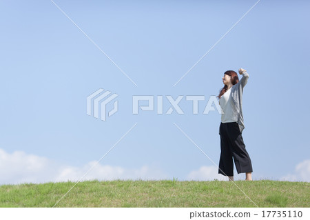 A woman growing pleasantly in the meadow A woman growing pleasantly in the meadow 17735110