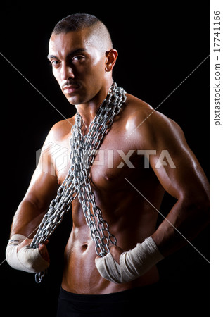Muscular man with chain on black background Muscular man with chain on black background 17741166