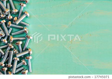 Pile of screw-nuts on the blue wooden background Pile of screw-nuts on the blue wooden background 17745071