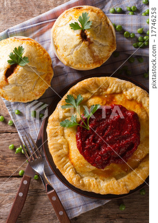 圖庫照片: australian meat pie on the table vertical top view