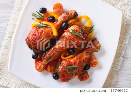 Chicken legs in tomato sauce on a plate top view Chicken legs in tomato sauce on a plate top view 17746612