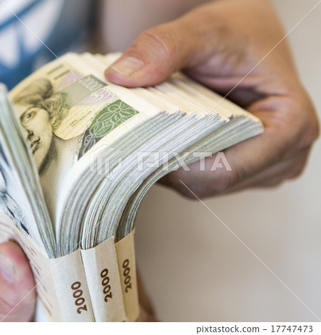 pack of money - big pile of banknotes in hand pack of money - big pile of banknotes in hand 17747473