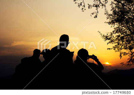 Silhouette of travelers with camera during sunset Silhouette of travelers with camera during sunset 17749680