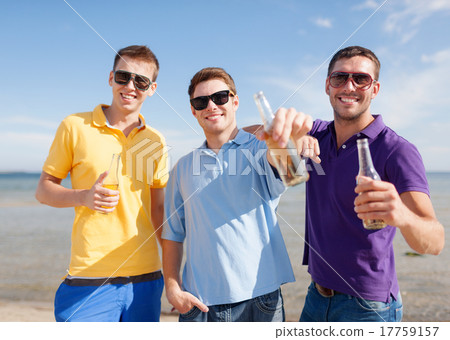 happy friends with beer bottles on beach 17759157