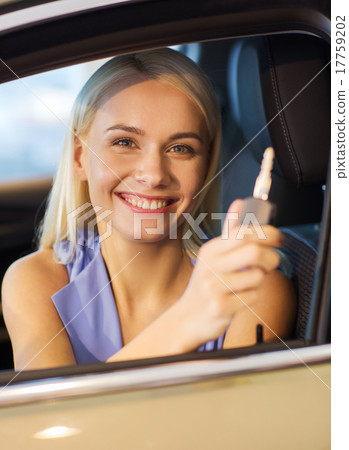 happy woman getting car key in auto show or salon happy woman getting car key in auto show or salon 17759202