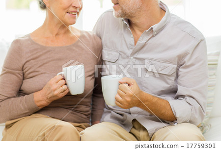 close up of happy senior couple with cups at home close up of happy senior couple with cups at home 17759301